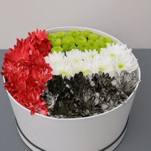 UAE National Day flower box arrangement with red green white and black chrysanthemums in a white round box