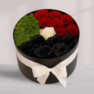 Black round box featuring preserved roses and preserved moss in red, white, green, and black UAE flag colors for National Day.